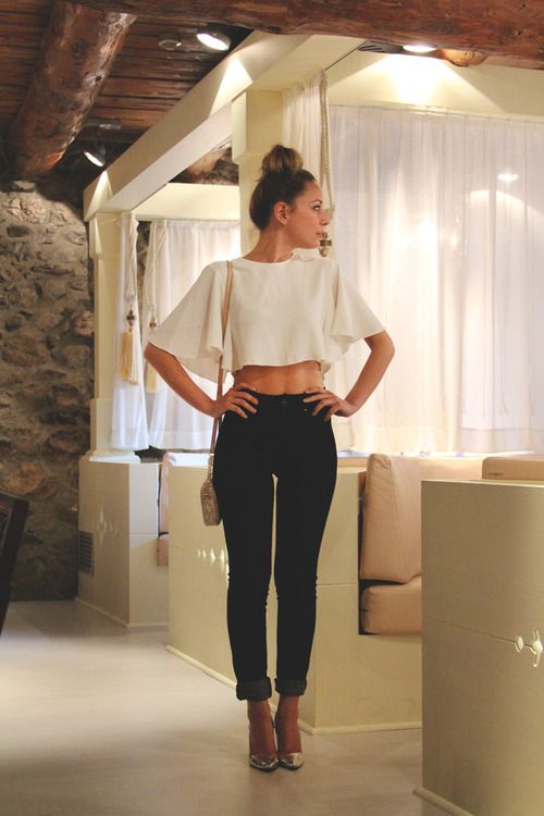 white crop top, black high waisted skinny jeans, over the shoulder .