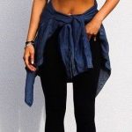 Crop top | black outfit with jean jacket tied around the waist .