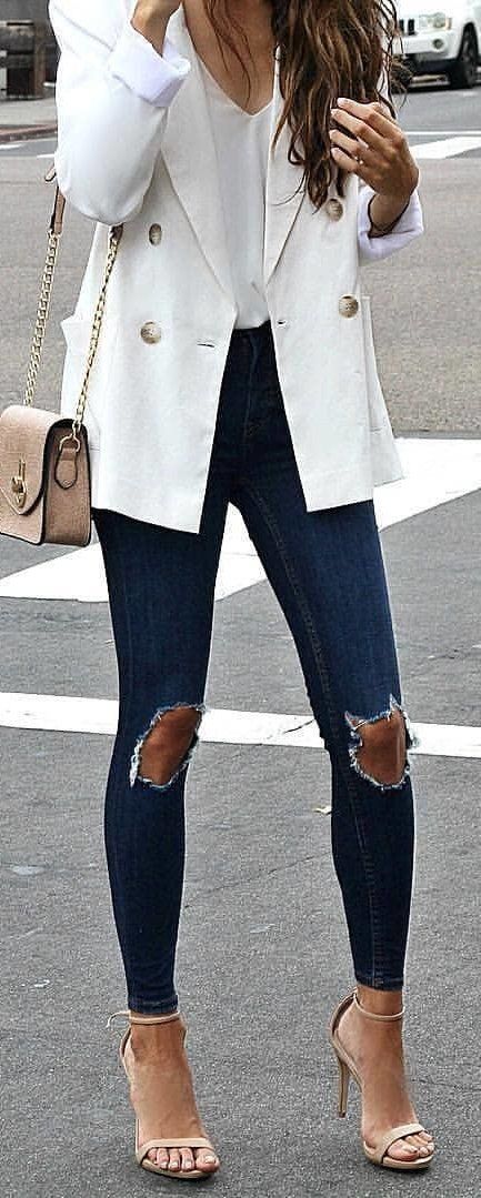 winter #outfits white blazer, distressed blue skinny jeans and .